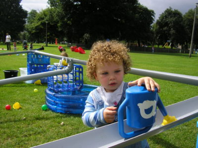 Child playing with watering can