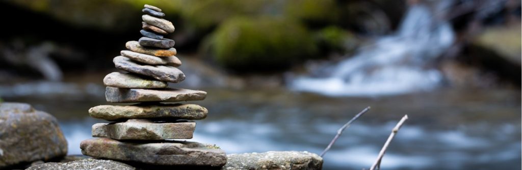 A small cairn beside a river
